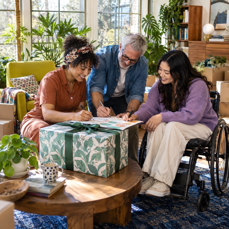 Three friends coordinate one shared housewarming gift in a bright sunroom.